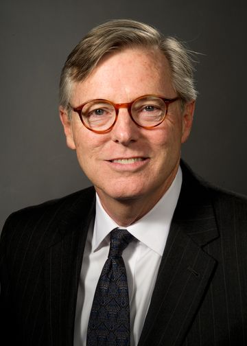 Michael Odlum wearing a dark suit and tie